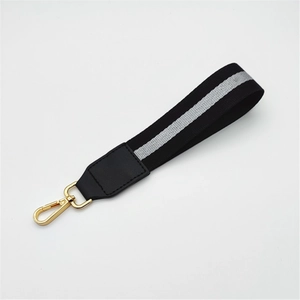 Close-up of black and grey striped braided wrist strap with gold swivel lobster clasp