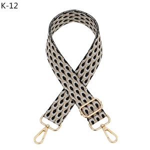 Detailed view of adjustable peacock pattern bag strap with gold metal lobster clasps