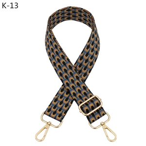 Close-up of geometric woven strap with golden lobster clasps and adjustable buckle