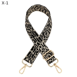 Detail of leopard print bag strap with golden metal swivel hooks and buckle
