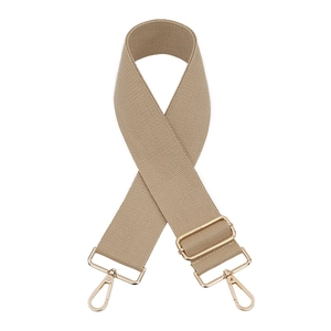 Detail of wide khaki woven bag strap with adjustable light gold metal buckles and lobster clips