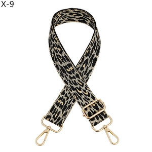 Macro detail of leopard print bag strap with adjustable light gold metal buckles