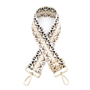 Detail of adjustable geometric diamond pattern woven bag strap with gold metal lobster clasp