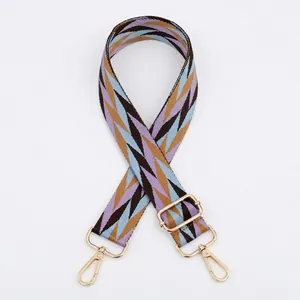 Adjustable bag strap featuring colorful geometric zigzag patterns and gold metal hooks
