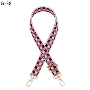 Adjustable checkerboard fabric bag strap in pink and purple with gold swivel hooks