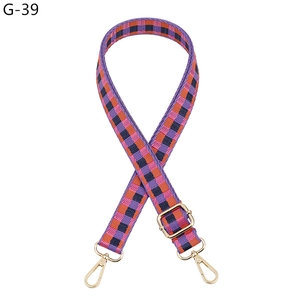 Detail of adjustable purple and orange checkered woven strap with gold metal lobster clasps