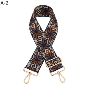 Close-up of ethnic geometric jacquard strap with golden hardware and star patterns