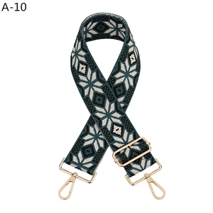 Detail of adjustable ethnic geometric pattern strap with golden metal lobster clasps