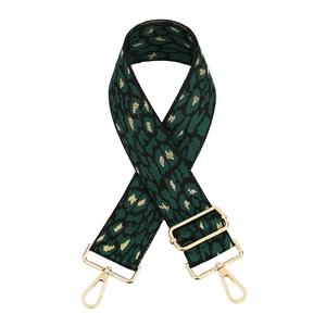 Adjustable leopard print bag strap with green woven pattern and gold hardware