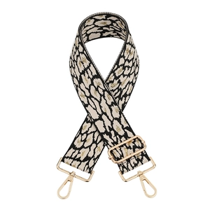 Close-up of leopard print woven bag strap with golden glitter and adjustable hardware