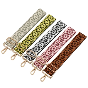 Adjustable wide woven guitar-style bag strap with ethnic geometric patterns and gold metal clips