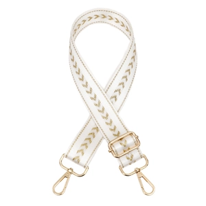 Detail of adjustable cream strap with golden V-pattern embroidery and metal hooks