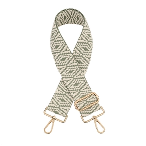 Detail of green woven strap with geometric pattern and golden metal buckles