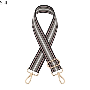 Detailed view of adjustable striped fabric shoulder strap with gold metal swivel hooks