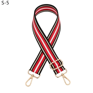 Detail of red white and black striped woven strap with light gold metal lobster clasps