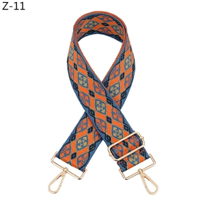 Close-up of diamond pattern woven bag strap with golden metal swivel hooks
