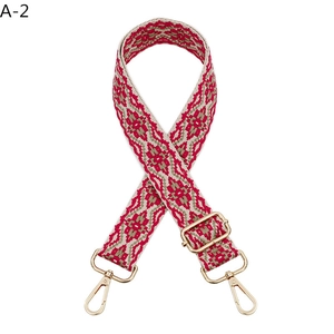 Close-up of bohemian geometric jacquard bag strap with golden lobster clasp buckles
