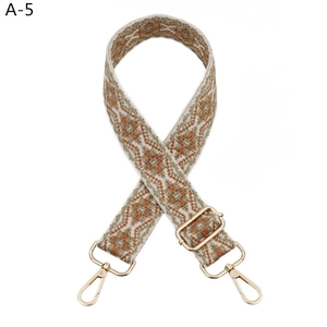 Detailed macro view of ethnic geometric jacquard strap with gold metal lobster clasps