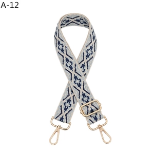 Close-up of geometric jacquard pattern webbing and gold metal buckle on a folk bag strap