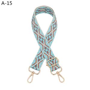 Detail of blue and brown geometric jacquard strap with gold metal hooks for handbags