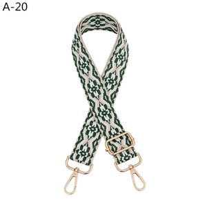 Detail of green and beige ethnic jacquard strap with gold metal buckle for bags