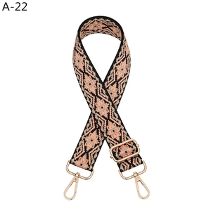 Detail of adjustable geometric weave strap with light gold metal swivel hooks for bags