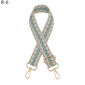 Close-up of geometric woven replacement shoulder strap with light gold metal lobster clasps