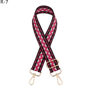 Adjustable wide replacement bag strap with pink and black zigzag woven patterns and gold clips