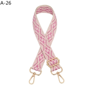 Close-up of ethnic style jacquard woven bag strap with pink geometric diamond pattern
