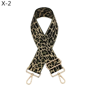 Detail of adjustable leopard print bag strap with golden metal swivel hooks and buckles