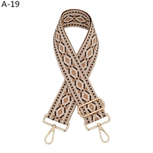 Détail de la bandoulière tissée réglable avec motif jacquard marron et crochets dorés
