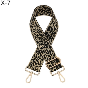 Detail of leopard print bag strap featuring gold metal hooks and adjustable buckle
