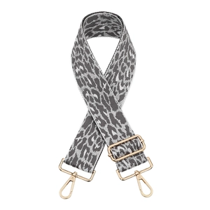 Adjustable leopard print bag strap with gold metal hardware on white background