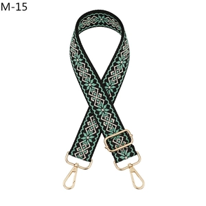 Detail of mint green ethnic woven bag strap with adjustable gold buckle and snap hooks