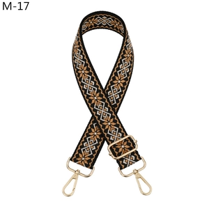 Detail of jacquard ethnic strap with golden metal lobster hooks and adjustable buckle