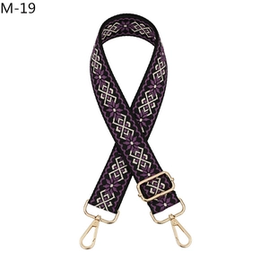 Detail showing adjustable purple ethnic jacquard guitar strap with gold lobster clasps
