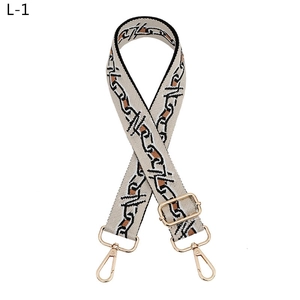 Adjustable canvas strap with geometric pattern and gold hardware for crossbody bags