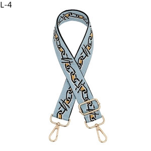 Adjustable light blue woven shoulder strap with black and orange chain pattern and gold clips