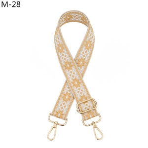 Detail view of Bohemian style ginger and white floral patterned adjustable bag strap