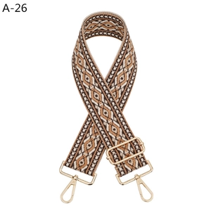 Detail of bohemian geometric jacquard bag strap with gold metal lobster clasps
