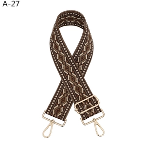 Close-up of ethnic geometric pattern woven bag strap with golden zinc alloy metal hooks
