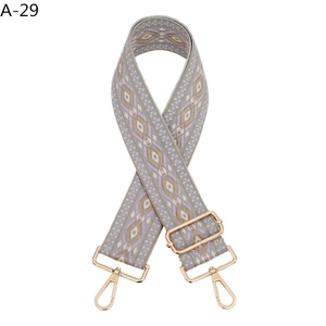 Close-up of adjustable gold hardware on a purple geometric ethnic style woven bag strap
