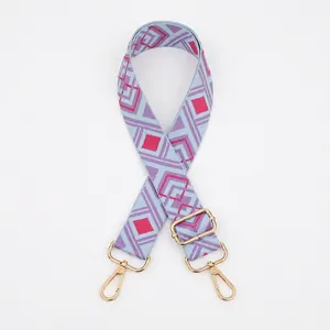 Detail of adjustable geometric diamond weave strap with gold metal rotating hooks