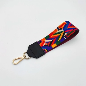 Colorful geometric woven strap with gold metal lobster clasp and black leather ends
