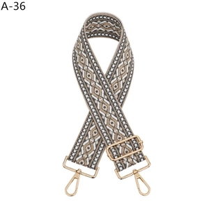 Close-up of ethnic style jacquard strap with gold metal lobster clasps and hardware