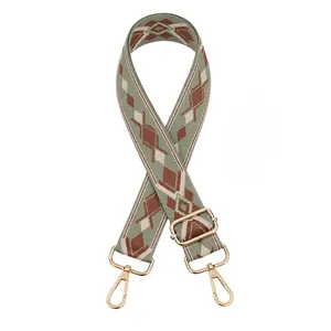 Adjustable woven shoulder strap with geometric diamond pattern and gold metal lobster clasps