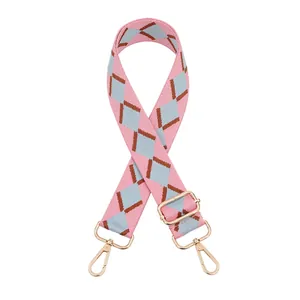 Adjustable wide woven shoulder strap with pink and blue diamond pattern and gold hardware