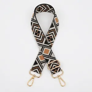Detail of adjustable woven bag strap with black, white, and brown diamond geometric patterns
