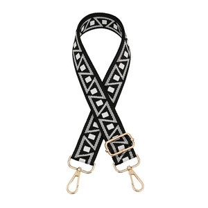 Adjustable crossbody bag strap with black and white geometric pattern and gold hardware