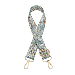 Detail of colorful geometric pattern bag strap with gold metal lobster clasps and buckle